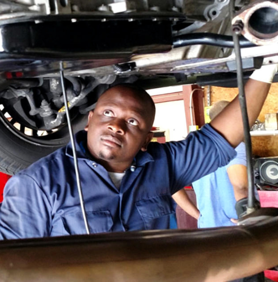 Mechanic draining car oil